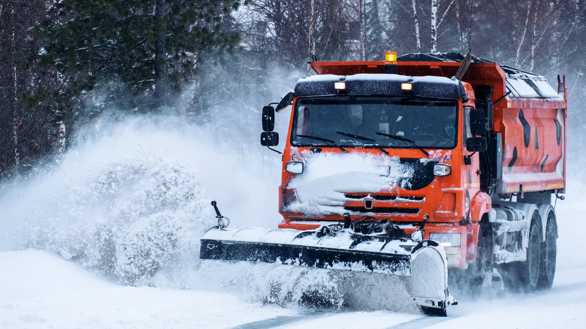 Snow plow clearing commercial lot